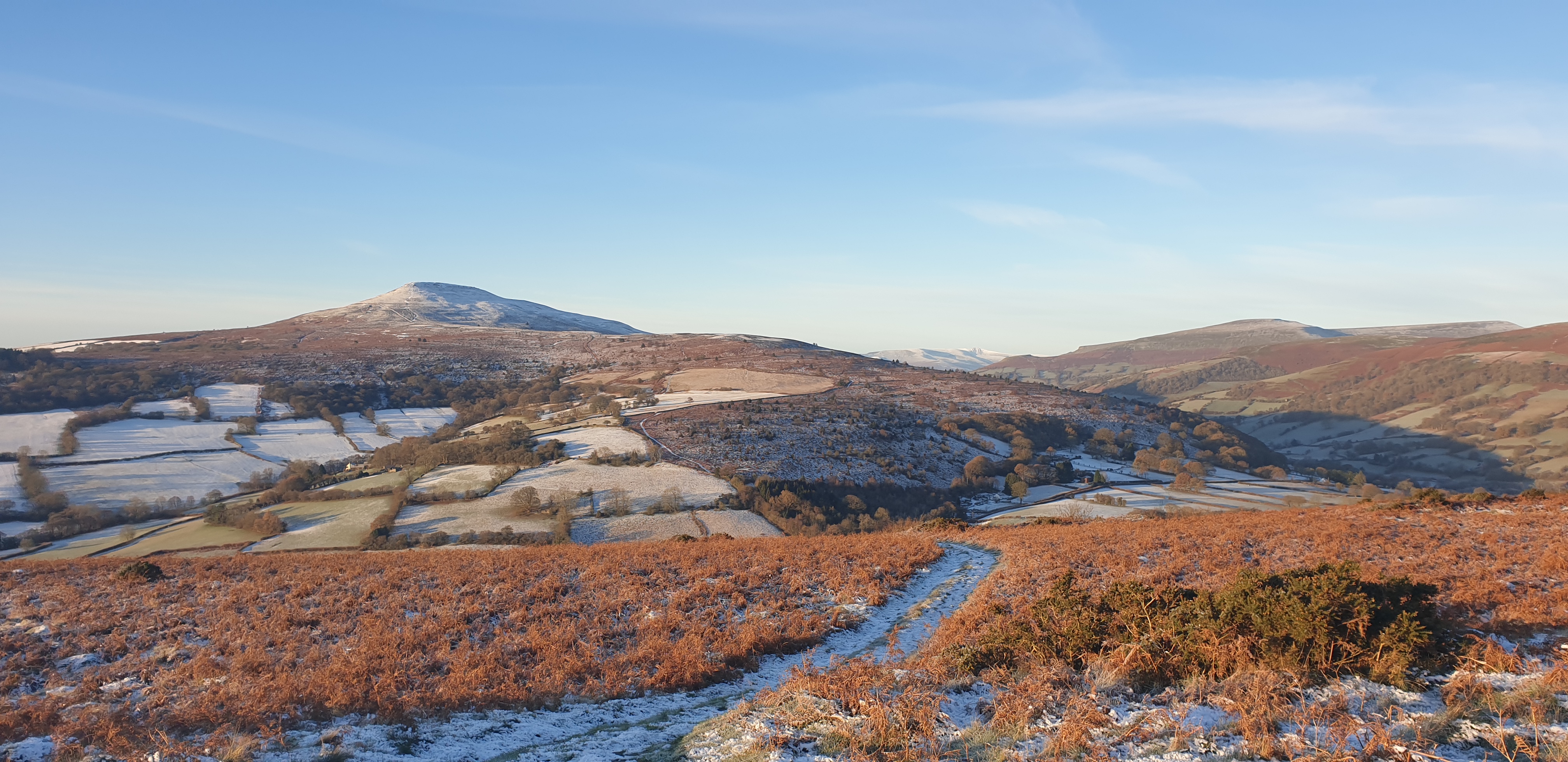 Standing on Bryn Arw looking at the Snow on the Sugar Loaf with Pen Y Fan in the far Distance
